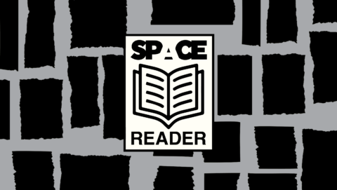 Illustration of black and grey background with 'space reader' written around an open book