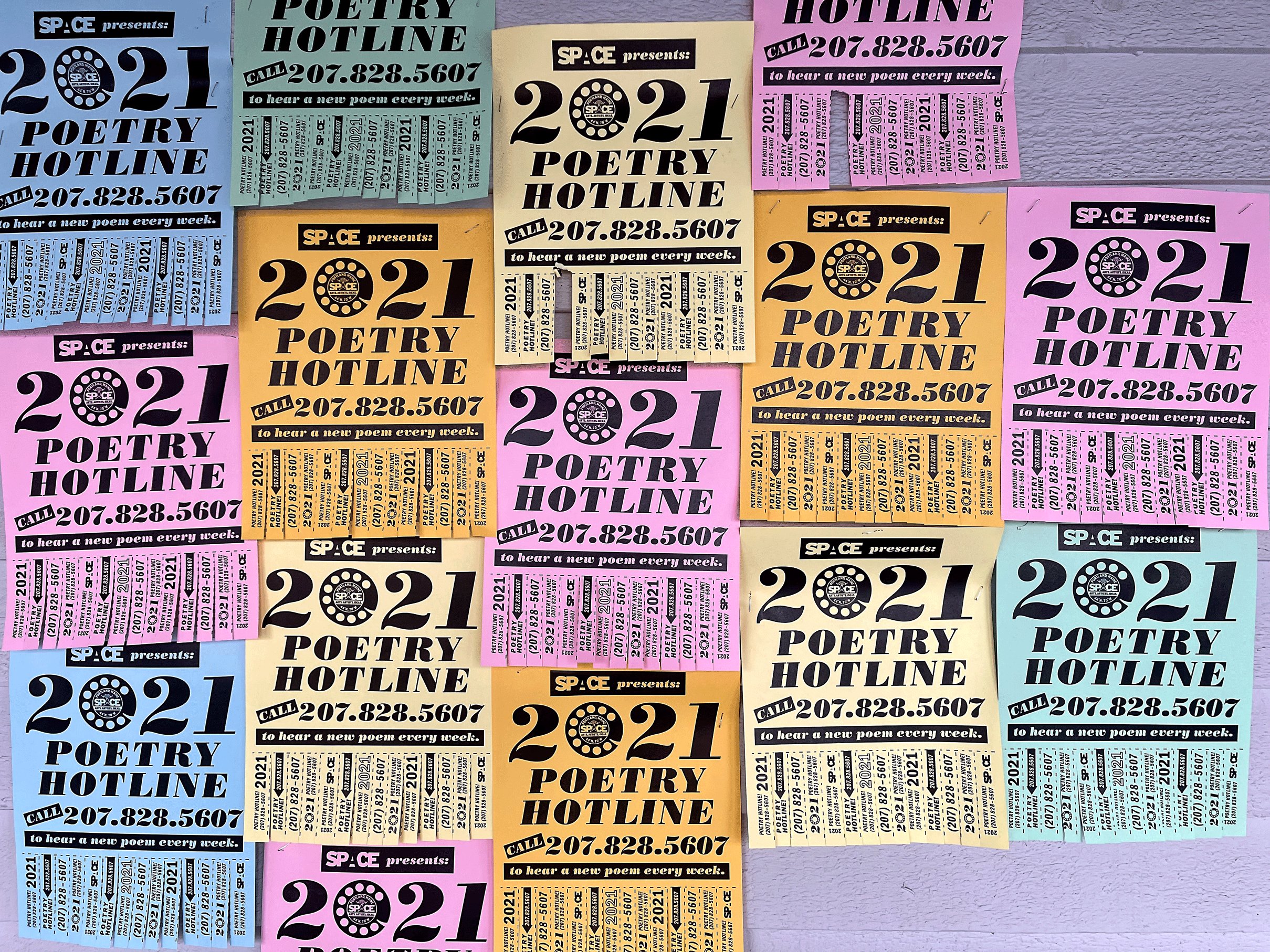 Flyers in multiple colors for the SPACE poetry hotline 207-828-5607