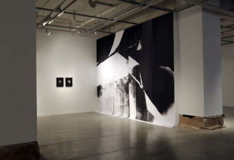 black and white photo installation in large gallery