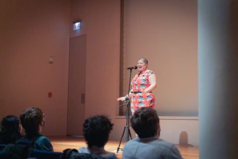 An image of a person speaking into a microphone