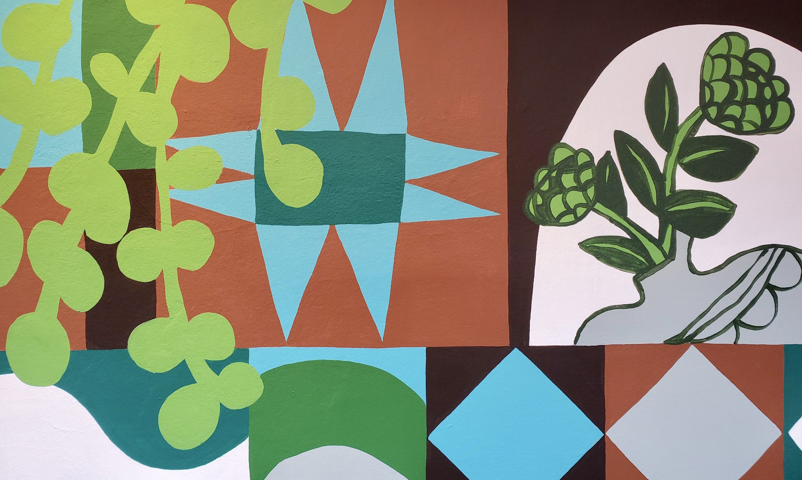 A detail photograph of the graphic mural with house plants by Rachel Adams.