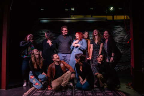 A group photograph of Salt students in various poses and facial expressions on the SPACE stage.