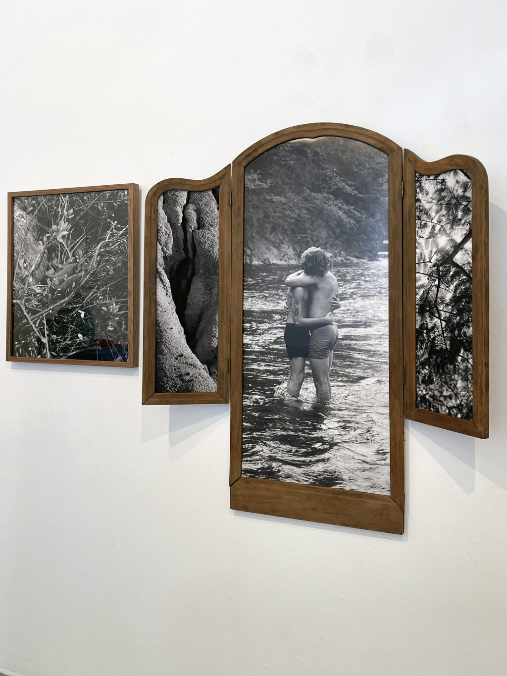 Framed photographs including a figure holding each other in a creek by Owen McCarter.