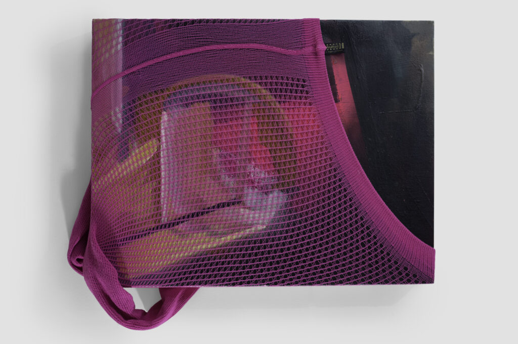 Pink tights stretched over a black painting by Angela Hoener.
