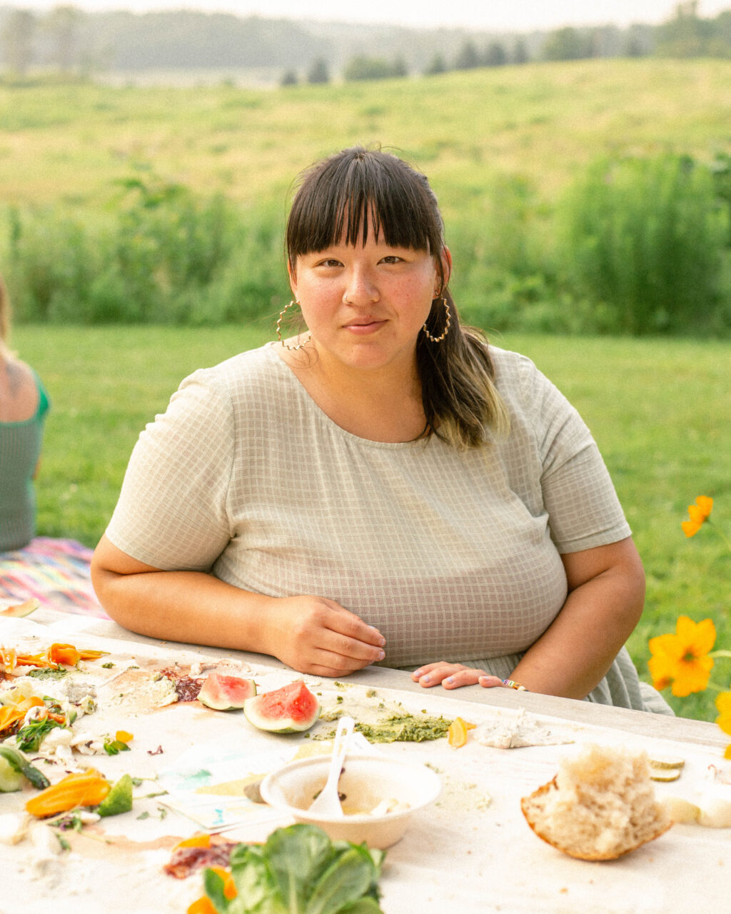 a photo of artist jenny ibsen, against a beautiful maine landscape