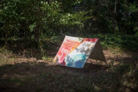 a photography of a painted canvas folded in the shape of a tent on Chebeague Island