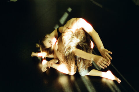 two tangled bodies in a dance performance (Photo by Jenna Joan)