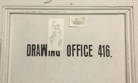 A photograph of a door that says "Drawing Office 416"