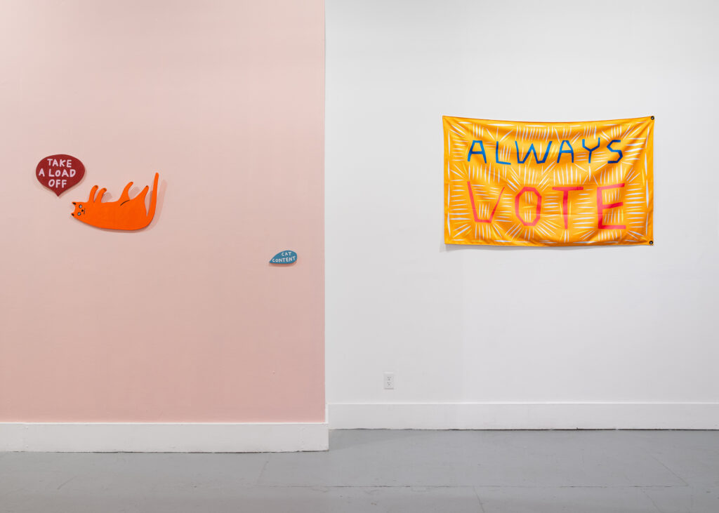 a pink wall with an orange cat saying "take a load off" and "cat content" and a white wall with a yellow flag that says "always vote" 