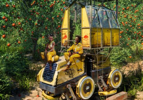 A detail of a photomontage by Jeyifous of two Black figures smiling, resting on top of a yellow futuristic harvesting car or machine of some kind amid fields of ripe apples.