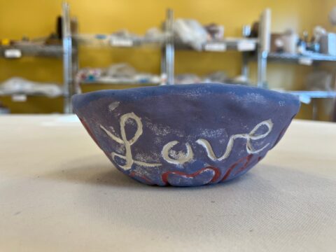 A Clay LOVE Bowl made by a resident at Maine Correctional Center photographed in September 2024