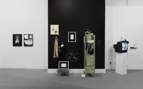 An exhibition view of Martha Schnee's 'Center For Cavernous Listening' shows several drawings, lab materials, and a locker. (Photo by Joel Tsui)